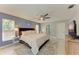 Spacious bedroom featuring a ceiling fan, stylish decor, and a comfortable king-size bed at 1127 133Rd E St, Bradenton, FL 34212
