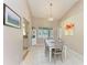 Cozy dining room with natural light and views of the backyard through a large window at 1127 133Rd E St, Bradenton, FL 34212