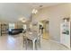 Open-concept dining area featuring a modern chandelier and views of the living room and kitchen at 1127 133Rd E St, Bradenton, FL 34212