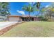 Inviting single-story brick home with a two-car garage and a meticulously landscaped front yard at 1127 133Rd E St, Bradenton, FL 34212