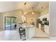 Open kitchen with a breakfast bar, stainless steel appliances, and easy access to the pool area at 1127 133Rd E St, Bradenton, FL 34212