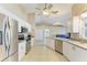 Well-equipped kitchen with stainless steel appliances, white cabinetry, and tile flooring at 1127 133Rd E St, Bradenton, FL 34212