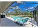 Relaxing screened-in pool and jacuzzi with lush landscaping creating a serene outdoor oasis at 1127 133Rd E St, Bradenton, FL 34212