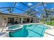 Sparkling screened-in pool and spa area, adjacent to a covered patio, perfect for outdoor living at 1127 133Rd E St, Bradenton, FL 34212