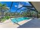 Relaxing screened-in pool and spa, with a beautiful pond view and complemented by a covered patio area at 1127 133Rd E St, Bradenton, FL 34212