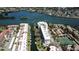 Stunning aerial view of waterfront condos with boat docks, lush landscaping, and serene water views at 1250 N Portofino Dr # 201, Sarasota, FL 34242