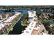 Breathtaking aerial view of waterfront condos with boat docks and lush landscaping along a scenic canal at 1250 N Portofino Dr # 201, Sarasota, FL 34242