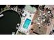 Aerial view of a community pool, tennis court, and shuffleboard courts offering resort-style amenities at 1250 N Portofino Dr # 201, Sarasota, FL 34242