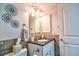 Updated bathroom featuring a modern vanity, decorative mirror, and neutral color palette at 1250 N Portofino Dr # 201, Sarasota, FL 34242