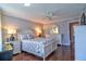 Comfortable bedroom with a ceiling fan, lamps, and wood floors at 1250 N Portofino Dr # 201, Sarasota, FL 34242