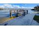 Picturesque view of the wooden dock with mooring, with a view of the wide river at 1250 N Portofino Dr # 201, Sarasota, FL 34242