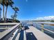 Picturesque waterfront view from a wooden dock with benches, perfect for enjoying the beautiful scenery at 1250 N Portofino Dr # 201, Sarasota, FL 34242