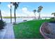 Scenic waterfront community featuring a manicured lawn, benches, and a pathway at 1250 N Portofino Dr # 201, Sarasota, FL 34242