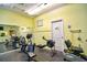 Community gym includes workout machines, a full wall mirror, and bright lighting at 1250 N Portofino Dr # 201, Sarasota, FL 34242