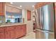 Efficient kitchen showcasing stainless steel appliances and a convenient breakfast bar at 1250 N Portofino Dr # 201, Sarasota, FL 34242