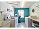The laundry room features a washer and dryer, sink, and colorful decor at 1250 N Portofino Dr # 201, Sarasota, FL 34242
