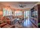 Comfortable living room features hardwood floors, a ceiling fan, and sliding glass doors at 1250 N Portofino Dr # 201, Sarasota, FL 34242