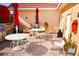 Outdoor patio space with tables, chairs, umbrellas, and grill, ideal for entertaining guests at 1250 N Portofino Dr # 201, Sarasota, FL 34242