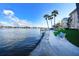 Enjoy waterfront views from this property with seating, dock, and palm trees at 1250 N Portofino Dr # 201, Sarasota, FL 34242