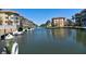 Scenic waterway featuring boats docked between waterfront residences and a serene water view at 1250 N Portofino Dr # 201, Sarasota, FL 34242