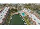 Aerial view of waterfront condos, a pool, spa, and shuffleboard courts at 1250 N Portofino Dr # 303, Sarasota, FL 34242