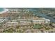 Aerial shot of condo community with tennis courts, boat docks, and water views at 1250 N Portofino Dr # 303, Sarasota, FL 34242