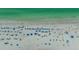 Overhead aerial of a beach featuring many blue beach umbrellas at 1250 N Portofino Dr # 303, Sarasota, FL 34242