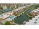 Aerial shot showing condo community, swimming pool, boat docks and canal at 1250 N Portofino Dr # 303, Sarasota, FL 34242