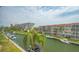 This aerial view shows condos on the canal front, boat docks and the beautiful blue sky at 1250 N Portofino Dr # 303, Sarasota, FL 34242