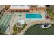 This aerial view features a community pool, spa, shuffleboard and canal-front condos at 1250 N Portofino Dr # 303, Sarasota, FL 34242