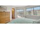 Bright bedroom featuring tile floors and sliding glass door to private balcony at 1250 N Portofino Dr # 303, Sarasota, FL 34242
