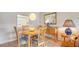 Cozy dining room features a round wood table, stylish light fixture, and ample natural light at 1250 N Portofino Dr # 303, Sarasota, FL 34242