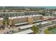 Exterior view of the condo building with parking and palm trees at 1250 N Portofino Dr # 303, Sarasota, FL 34242