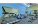 Community gym with a treadmill, elliptical, various weight machines and mirror at 1250 N Portofino Dr # 303, Sarasota, FL 34242