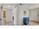 Inviting condo hallway with tiled floors, painted walls, and entry to the bath and rooms beyond at 1250 N Portofino Dr # 303, Sarasota, FL 34242