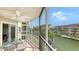 Outdoor screened patio features ample waterfront views, with bright Florida sunshine and tiled floors at 1250 N Portofino Dr # 303, Sarasota, FL 34242