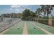 Well-maintained shuffleboard courts with lush landscaping, providing a recreational area for residents at 1250 N Portofino Dr # 303, Sarasota, FL 34242
