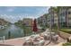 Community waterfront area with tables, chairs, and boat docks, offering a relaxing and scenic view at 1250 N Portofino Dr # 303, Sarasota, FL 34242