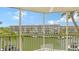 Enjoy expansive views of the waterfront from this screened patio, boats passing through the serene canal at 1250 N Portofino Dr # 303, Sarasota, FL 34242