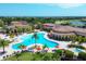 Scenic aerial view of the expansive community pool area with ample seating and lush landscaping at 13145 Amerigo Ln, Venice, FL 34293