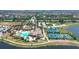 Spacious aerial view of tennis courts, pool, and luxury community with lush landscaping and lake views at 13145 Amerigo Ln, Venice, FL 34293