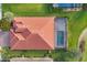 An aerial view showcasing a tile roof, pool, and well-maintained landscaping at 13145 Amerigo Ln, Venice, FL 34293
