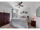 Cozy bedroom featuring a window view and complemented by a ceiling fan for added comfort at 13145 Amerigo Ln, Venice, FL 34293