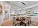 Chic dining room with modern lighting, neutral decor, and convenient access to other living spaces at 13145 Amerigo Ln, Venice, FL 34293