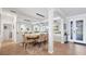 Bright dining room featuring large mirror, modern chandelier, adjacent living spaces, and neutral decor at 13145 Amerigo Ln, Venice, FL 34293