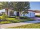 Attractive home with a three-car garage, red tile roof, well-maintained landscaping, and a brick driveway at 13145 Amerigo Ln, Venice, FL 34293