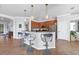 Charming kitchen features an island with barstool seating, granite countertops, and stainless steel appliances at 13145 Amerigo Ln, Venice, FL 34293