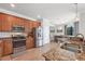 Well-equipped kitchen featuring stainless steel appliances, granite counters, and a view into the dining area at 13145 Amerigo Ln, Venice, FL 34293
