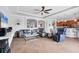 Open-concept living room with tile flooring, neutral decor, and seamless flow to kitchen at 13145 Amerigo Ln, Venice, FL 34293