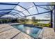 Well-maintained pool with a screened enclosure and a scenic lake view, perfect for outdoor enjoyment at 13145 Amerigo Ln, Venice, FL 34293